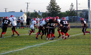 White team blockers seal off the backside as the runner goes to the left.