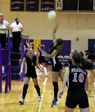 Ashley Schaeffer stretches for a spike against Genesee. #6 is Bridget Enneking and #10 is Tiffany Schaeffer.