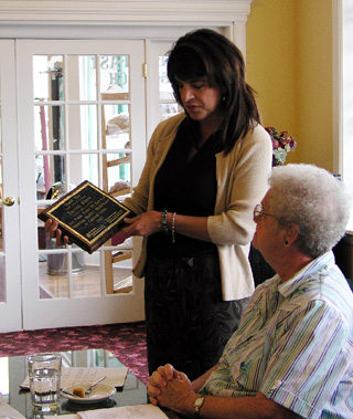 Casey Meza presents Harriet Reece a plaque on her retirement.