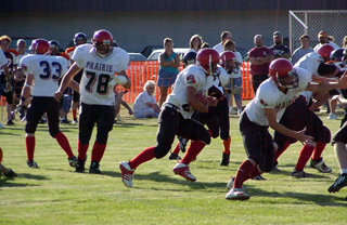 Danny Riener carries the ball. #78 is J.D. Riener and 33 is Tim Russell.