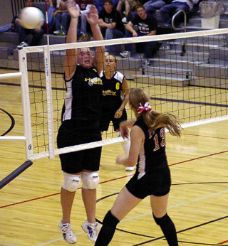 Kylie Uhlorn spikes the ball past an attempted block for a kill.