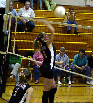 Ashley Schaeffer spikes the ball at Timberline as Randi Schumacher gets ready for the return.