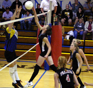 Tiffany Schaeffer guides a spike past a Nezperce blocker for one of her 18 kills in the match.