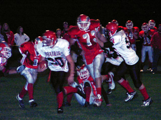 Ryan Daly gets past the first line of defense on a run. At right is Clark Tacke.
