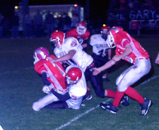 Ryan Daly and Corey Schaeffer meet at the quarterback for a sack. In the background is Daniel Sigler.