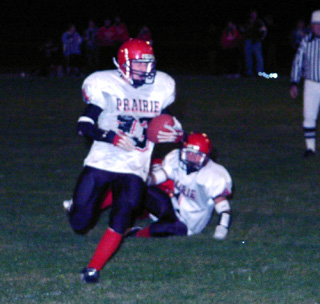 Tim Russell carries the ball for yardage.
