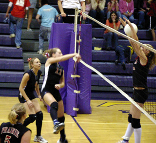 Ashley Schaeffer spikes the ball between the hands of the Deary defender.