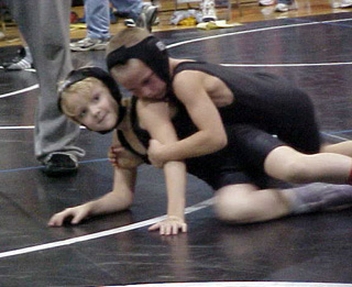 Kellie Heitman, bottom, and Hunter McWilliams wrestled each other.