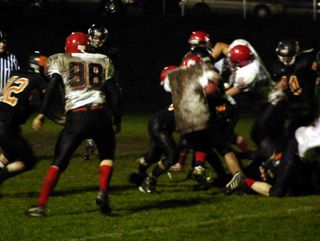 Mat Forsmann battles for yardage. At left is Chris Schumacher.