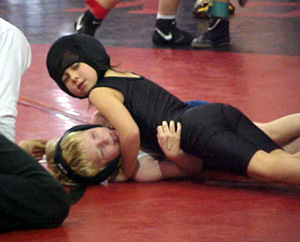 Rhianna Fox is about to pin her opponent.