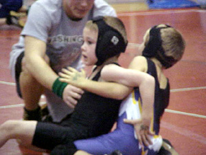 Jace Perrin tries to break the hold of his opponent.