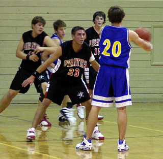 Mat Forsmann guards the ball while J.D. Riener battles for position. At right is Josh Gabica.