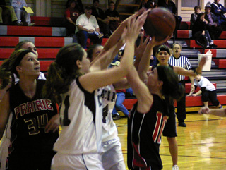 Tiffany Schaeffer puts up a shot in traffic against Kamiah. Brittny Behler is at left.