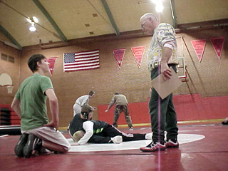 Head coach Steve Lamont offers some tips to a wrestler.