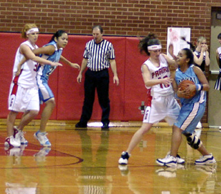 Tiffany Schaeffer guards the ball while Natalie Arnzen battles for position.