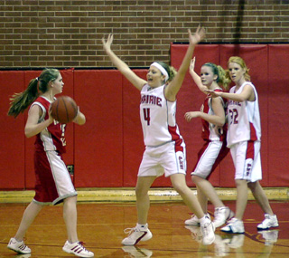 Bridget Enneking and Natalie Arnzen play defense against C.V.