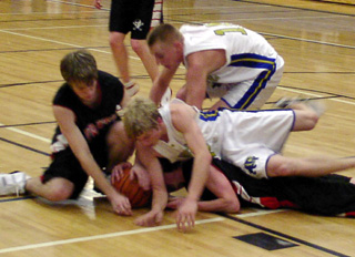 Corey Schaeffer (on the bottom) and Sean Daly go after a loose ball at Genesee.