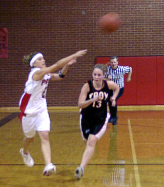 Nicole Nida whips a pass toward the lane while driving downcourt after a steal.