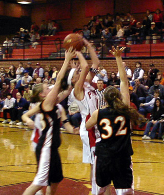 Tiffany Schaeffer puts up a shot as she is surrounded by Troy defenders.