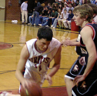 Corey Schaeffer drives along the lane toward the hoop.