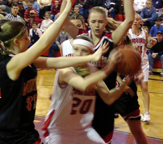 Kylie Uhlorn looks to pass back outside after getting surrounded by Deary defenders.