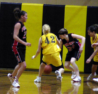 Kylie Uhlorn goes after a loose ball. At left is Becky Gehring.