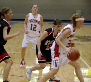 Brittny Behler dribbles around a defender as Ashley Jackson watches.