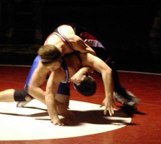 Jake Wimer puts a half-nelson on his opponent.