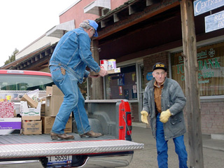 Ralph Terhaar and Don Tacke load a pickup from the old food bank location for transport to the new location.
