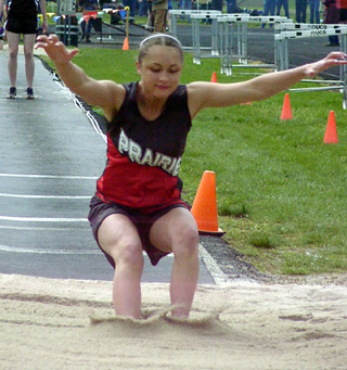 Casandra Schaeffer buries her feet in the pit in the long jump.