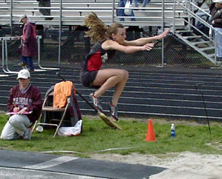 Gina Holthaus soars in the long jump.