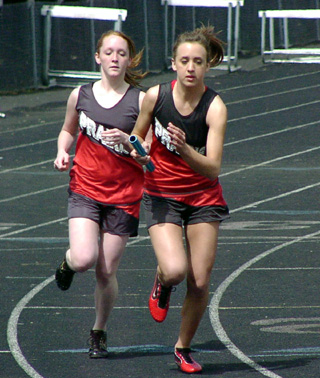 Kayla Lorentz hands off to Randi Schumacher in a relay.