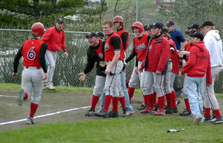 The whole team greets Dan Riener at home after his game-ending 2-run homer against Genesee.