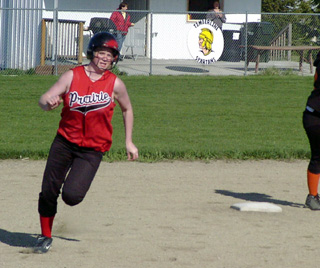 Kara Guyer heads for third with a triple against Troy.