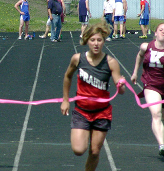 Nicole Nida breaks the tape to win the 100 meter dash at Kamiah.