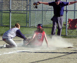 Tiffany Schaeffer is called safe at home as she scores on a passed ball against Lewis County.