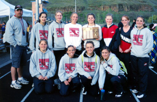 The girls track team with the White Pine League Meet championship trophy.