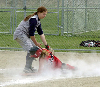 Carolyn Sonnen slides into home with a run against Lewis County.