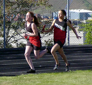 Casandra Schaeffer hands off to Kayla Lorentz in one of the relays.