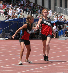 Kayla Lorentz hands off to Gina Holthaus in the 4x400 relay.
