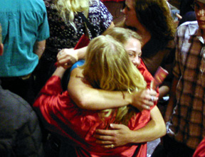 A grad gets a hug from a well-wisher.
