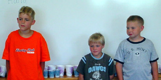 Isaiah Shears, Matt Leonard, and Jared Sonnen looking during a game of Heads-up, 7-up while on a classroom break during summer school.