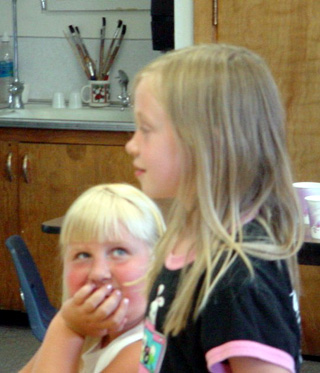Stephanie Jungert looks on while Bailie Gehring answers a question during the summer school session.