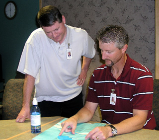 Gary McEwen, PT, (seated) goes over the Splash, Pedal, Dash route map with Craig Morris, one of this year's participants in the August 12 Grangeville event.