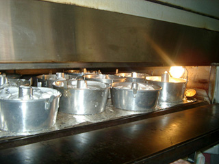 Cake tins fill the bakery's oven and the aroma of fresh-baked cake wafts through the monastery halls during the daylong angel food cake bake-a-thon for the Raspberry Festival.