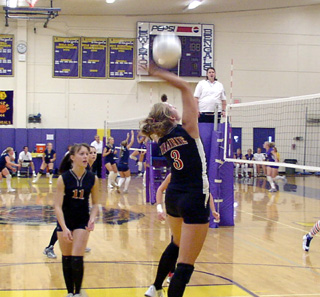 Carolyn Sonnen spikes the ball after a set from Alli Holthaus, 11.