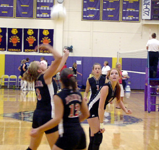 Carolyn Sonnen is about to hit the ball. Also shown from left are Brooke Holthaus, Randi Schumacher and Sarah Arnzen.