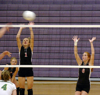 Randi Schumacher and Sarah Arnzen try to time their leaps to get a block.
