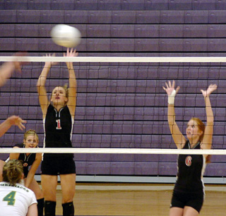 Randi Schumacher and Sarah Arnzen try to time their leaps to get a block.