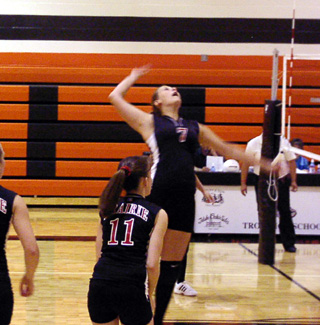 Tessica Nuxoll goes for a spike. Alli Holthaus, 11, made the set.
